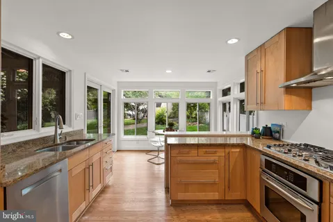 a kitchen with a dining table and chairs