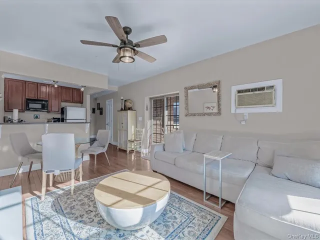 a living room with furniture a rug and a flat screen tv