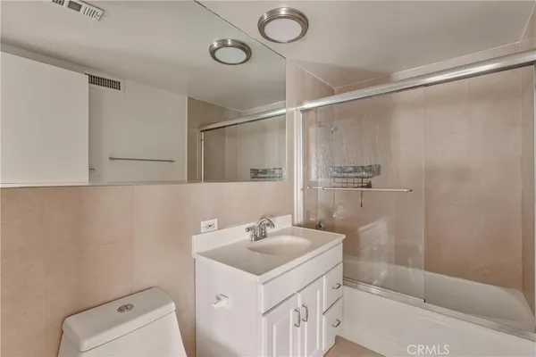 a bathroom with a glass shower door
