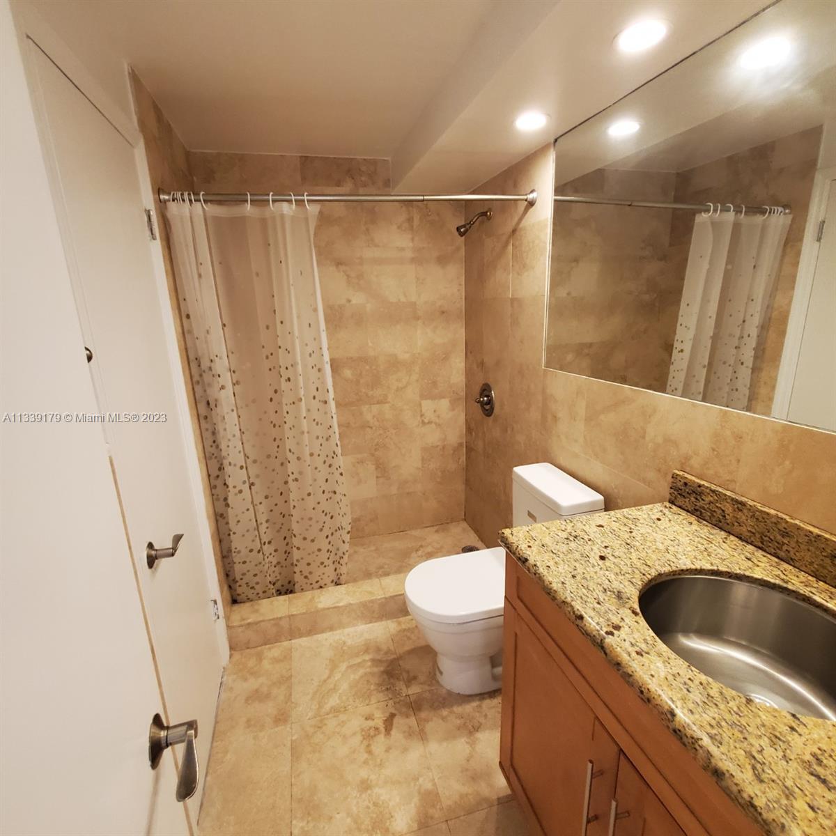 245 18th Street, Unit 403 Miami Beach, FL 33139 - Photo 16 of 30 a bathroom with a sink a toilet and shower