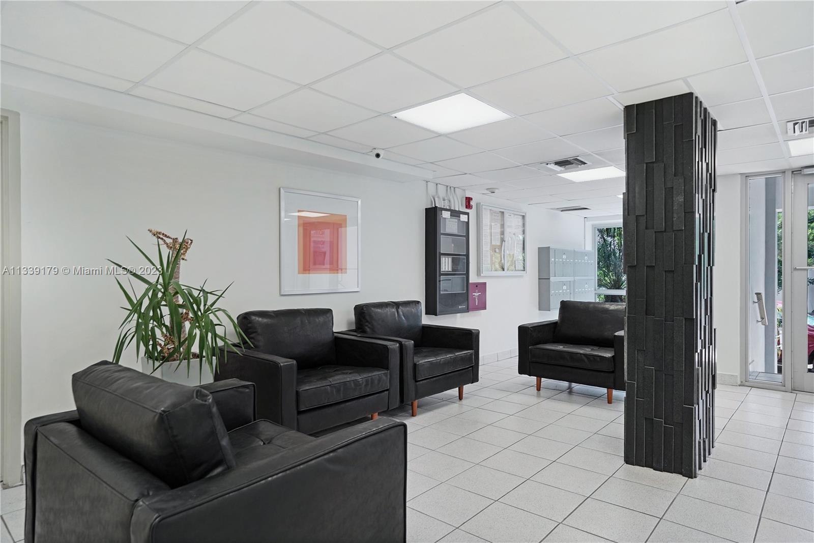 245 18th Street, Unit 403 Miami Beach, FL 33139 - Photo 27 of 30 a living room with furniture and wooden floor