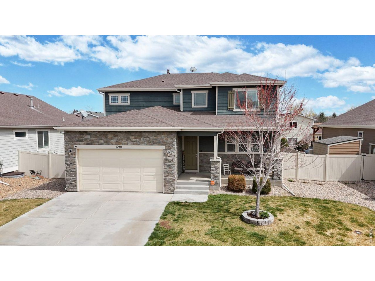 620 Cimarron Trail Ault, CO 80610 - Photo 1 of 37 a house view with a garden space