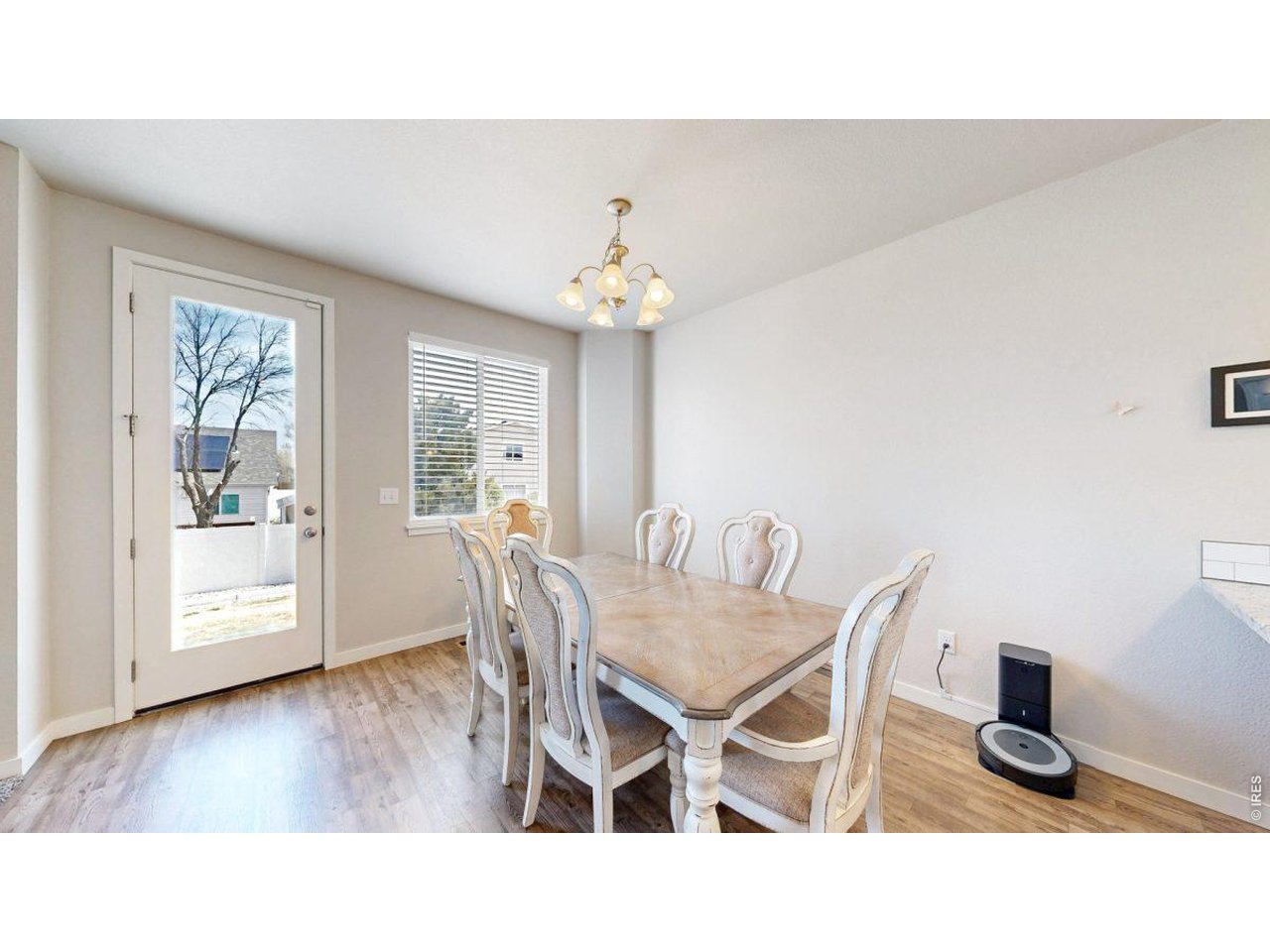 620 Cimarron Trail Ault, CO 80610 - Photo 12 of 37 a dining room with furniture and wooden floor