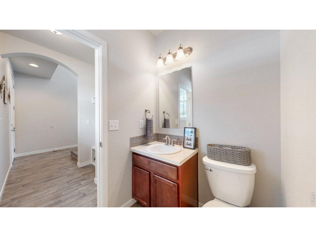 620 Cimarron Trail Ault, CO 80610 - Photo 14 of 37 a bathroom with a toilet a sink and mirror