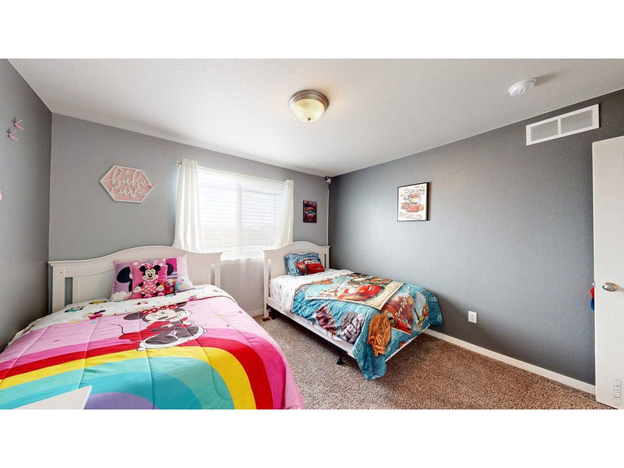 620 Cimarron Trail Ault, CO 80610 - Photo 20 of 37 a bedroom with a bed and a chandelier