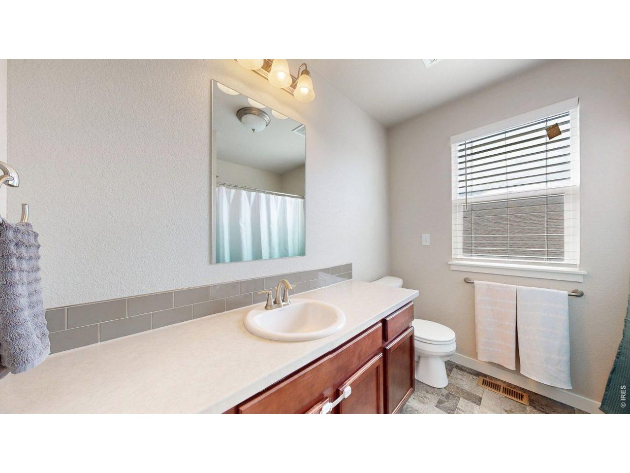 620 Cimarron Trail Ault, CO 80610 - Photo 26 of 37 a bathroom with a sink vanity mirror and toilet
