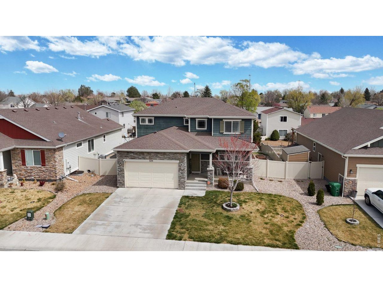 620 Cimarron Trail Ault, CO 80610 - Photo 33 of 37 a view of a big house with a big yard and potted plants