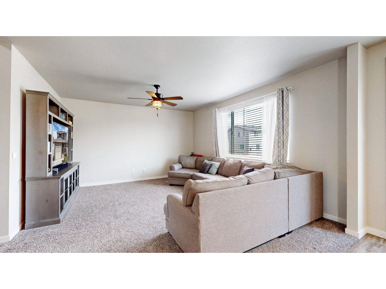 620 Cimarron Trail Ault, CO 80610 - Photo 6 of 37 a living room with furniture and a flat screen tv
