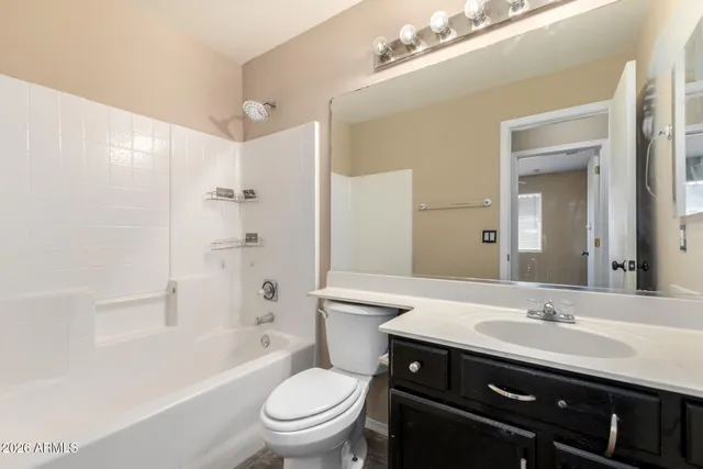 a bathroom with a sink a toilet a mirror and shower