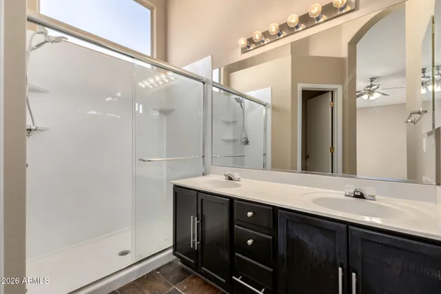 a bathroom with a double vanity sink and mirror