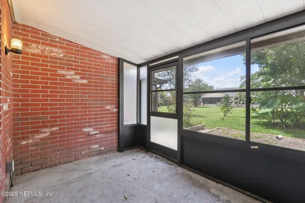an empty room with large windows