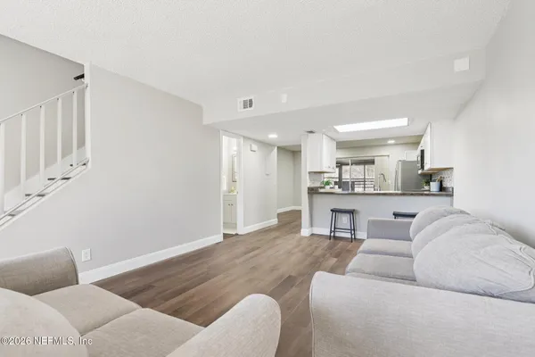 a living room with furniture and kitchen view