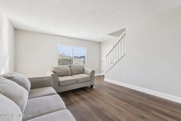 a view of empty room with wooden floor
