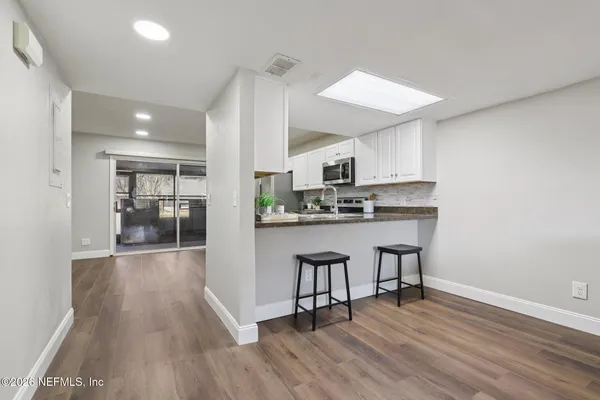 a view of empty room with wooden floor