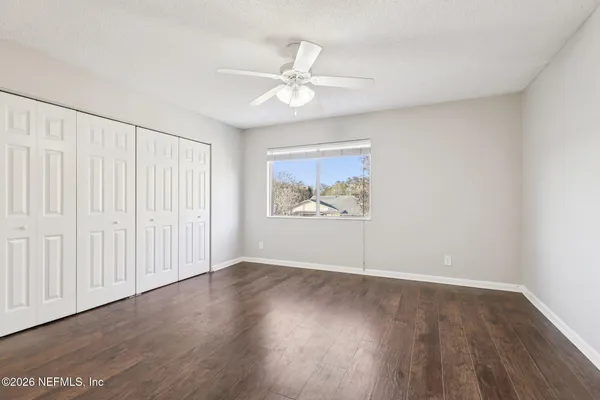 a view of an empty room with wooden floor