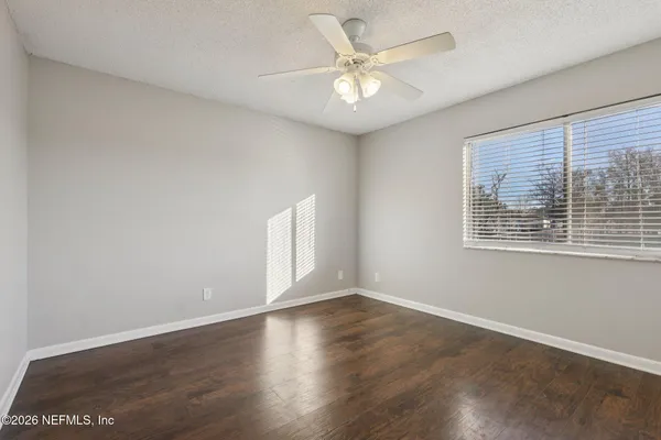 wooden floor in an empty room with a window