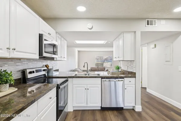 a kitchen with a sink stove and cabinets