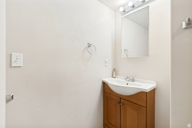 843 Deer Flat Road Tooele, UT 84074 - Photo 12 of 27 Compact bathroom vanity featuring a white integrated sink and light wood cabinetry