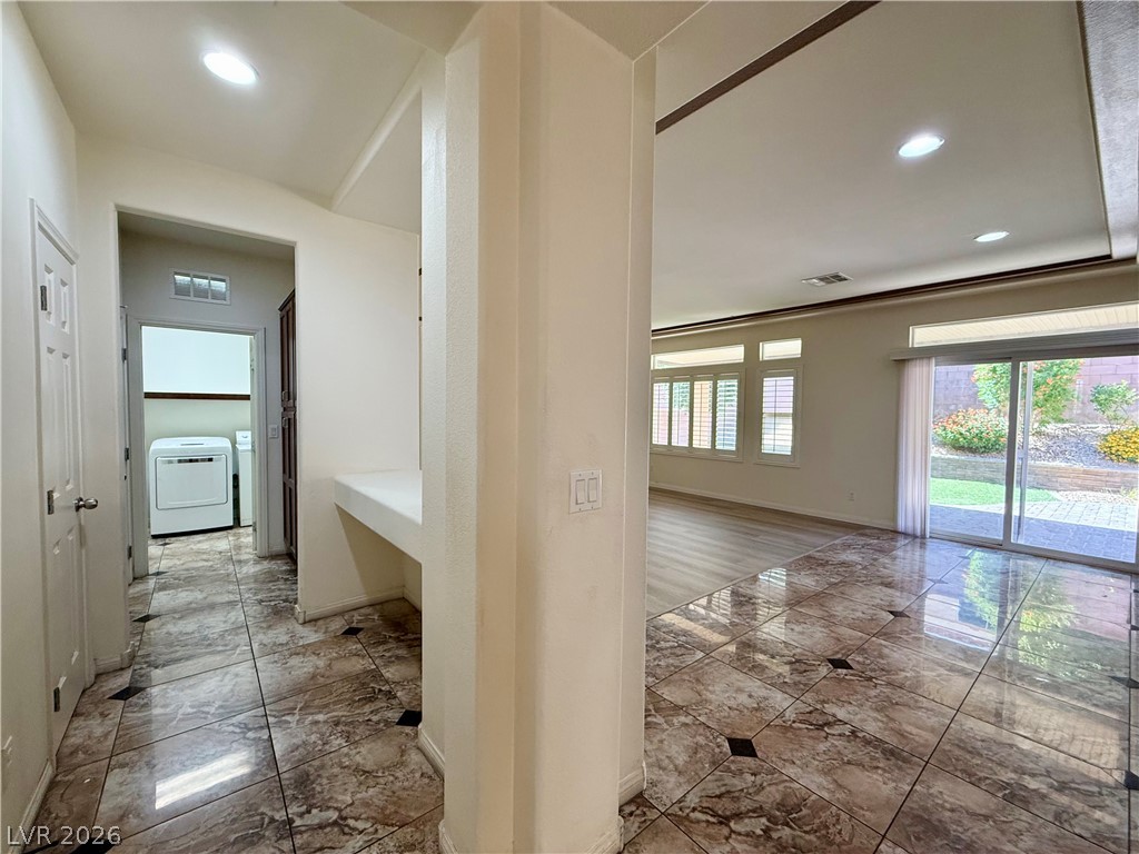 6459 Parrot Ridge Court Las Vegas, NV 89139 - Photo 6 of 23 A well-lit interior space with a blend of elegant tile and warm wood-look flooring, offering direct outdoor access.