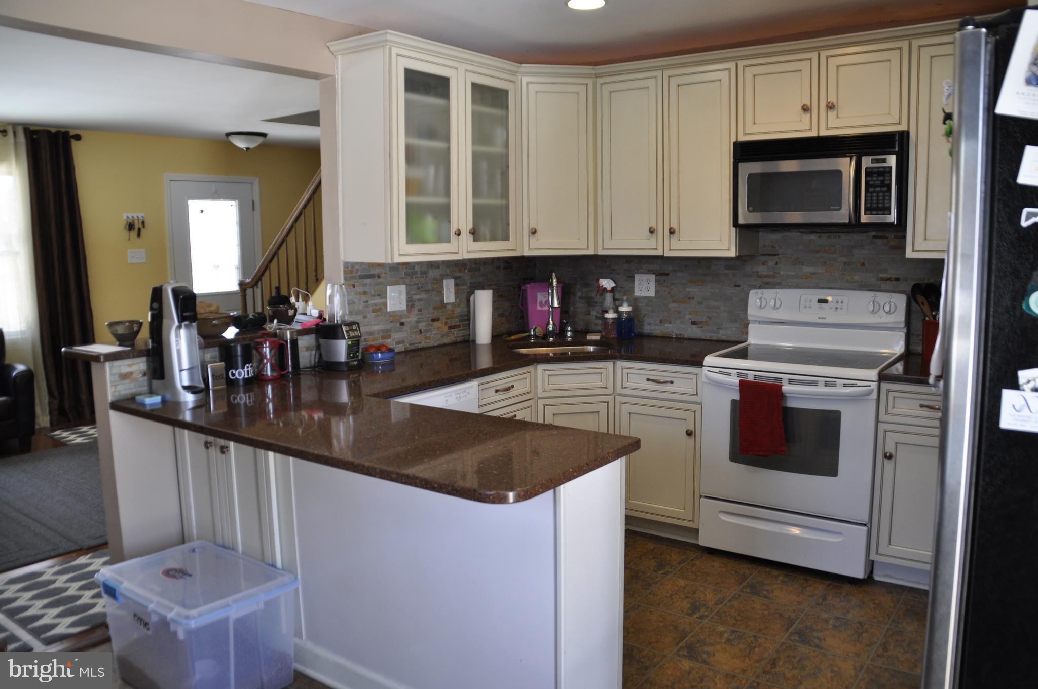 16005 Dark Hollow Road Upperco, MD 21155 - Photo 6 of 17 a kitchen with stainless steel appliances granite countertop a stove and a microwave