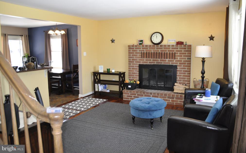 16005 Dark Hollow Road Upperco, MD 21155 - Photo 8 of 17 a living room with furniture a fireplace and a large window