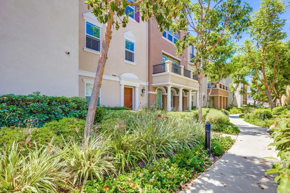 8065 Picasso Stanton, CA 90680 - Photo 1 of 1 a front view of a multi story residential apartment building with yard and green space