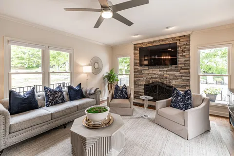 a living room with furniture and a fireplace