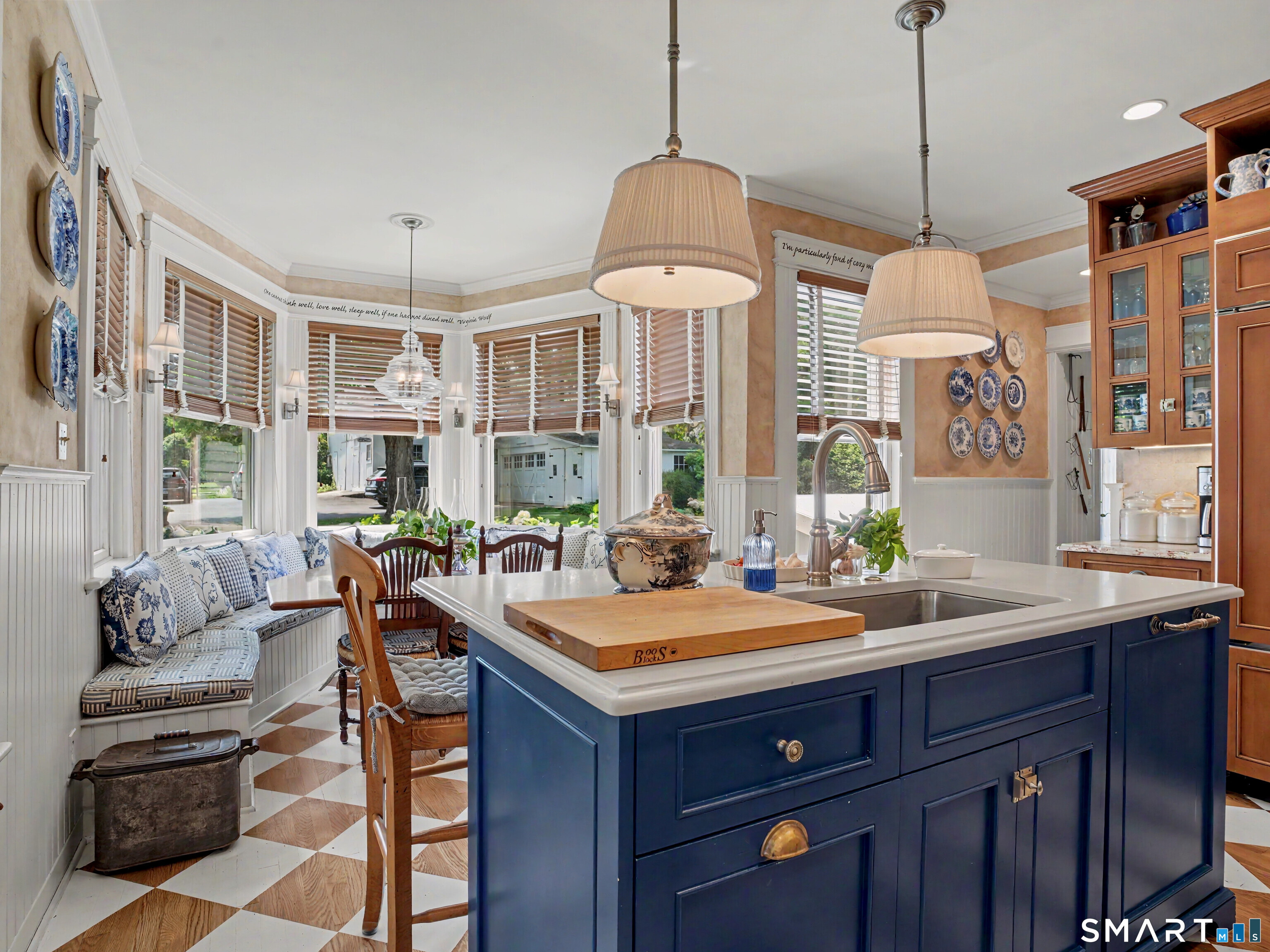 2477 Bronson Road Fairfield, CT 06824 - Photo 12 of 39 a room with a chandelier and a dining table with chairs