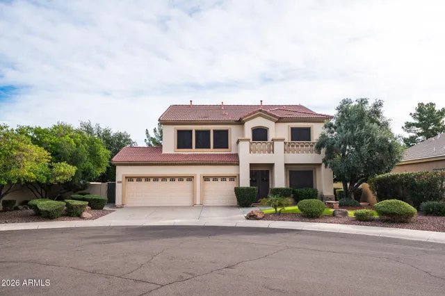 a front view of a house with a garden and garage