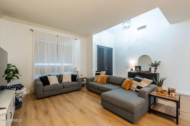 a living room with furniture kitchen and a fireplace