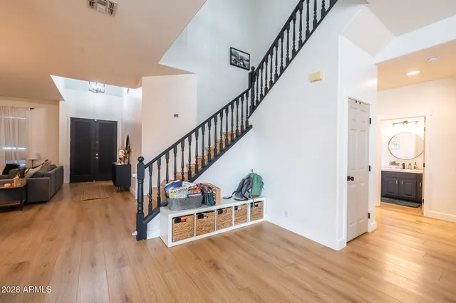 a kitchen with stainless steel appliances a refrigerator a stove a sink a dining table and chairs