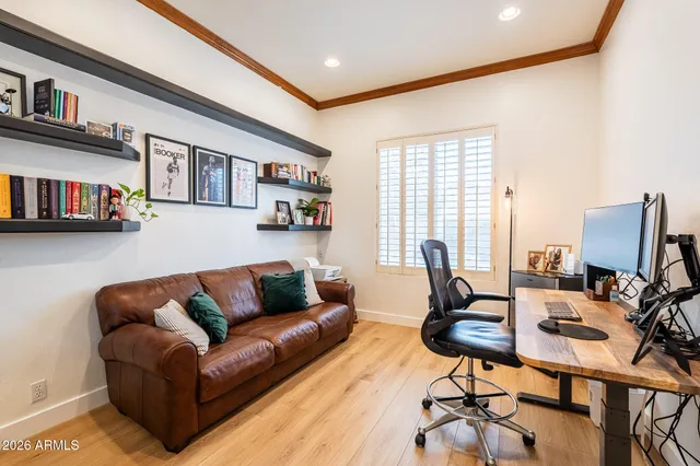 a kitchen with stainless steel appliances kitchen island granite countertop a refrigerator a stove top oven and a dining table with wooden floor