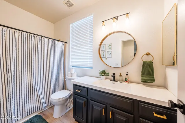 a spacious bedroom with a bed and a chandelier