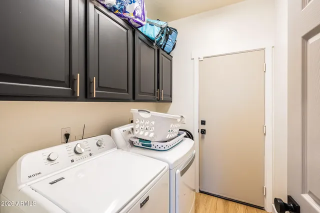 a bathroom with a double vanity sink mirror and bathtub