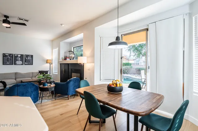 a living room with furniture chandelier and a window