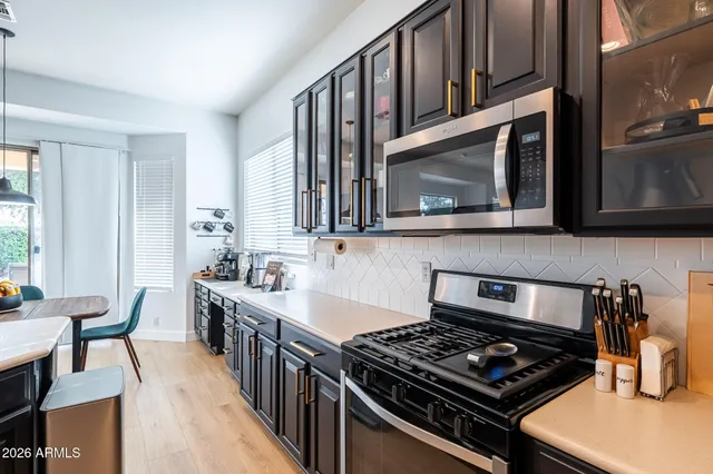 a living room with furniture a chandelier and a flat screen tv