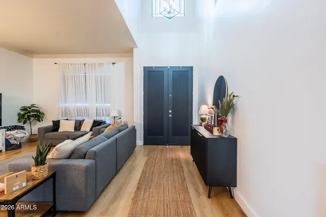 a living room with furniture and a lamp