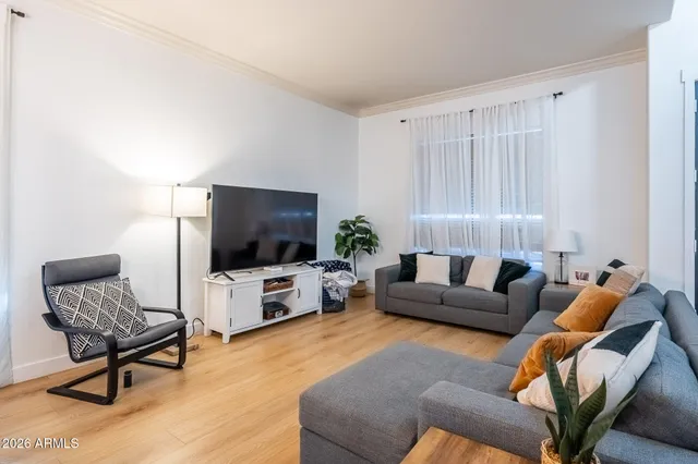 a living room with furniture a fireplace and a window