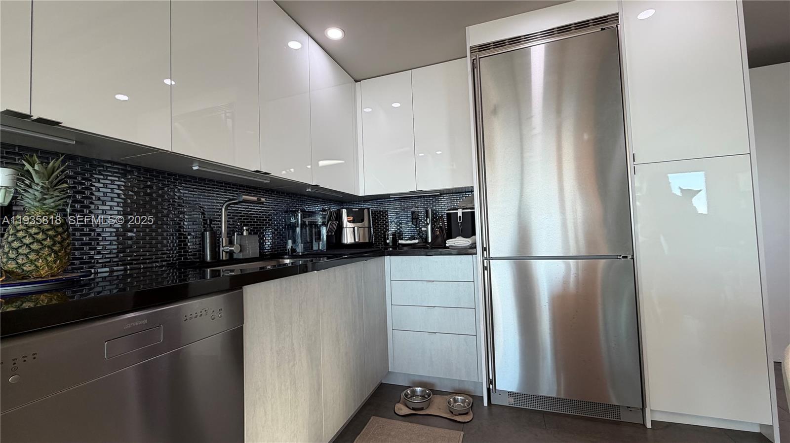 92 Southwest 3rd Street, Unit 3607 Miami, FL 33130 - Photo 16 of 33 a kitchen with stainless steel appliances a refrigerator and a stove top oven