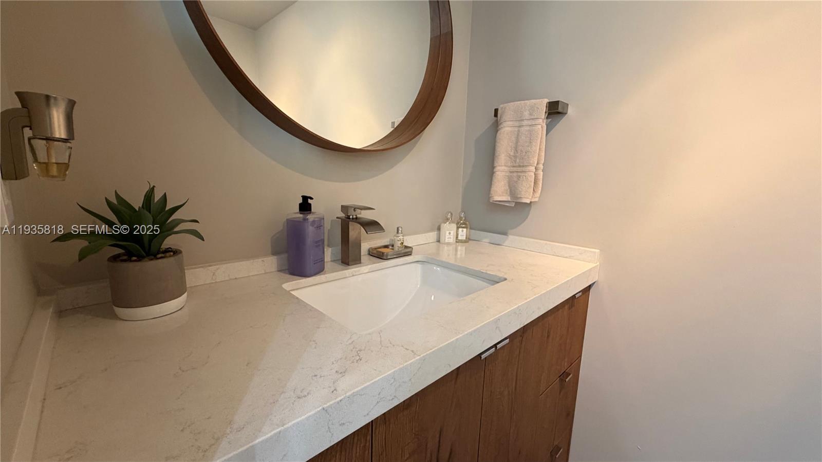 92 Southwest 3rd Street, Unit 3607 Miami, FL 33130 - Photo 29 of 33 a bathroom with a sink and a mirror