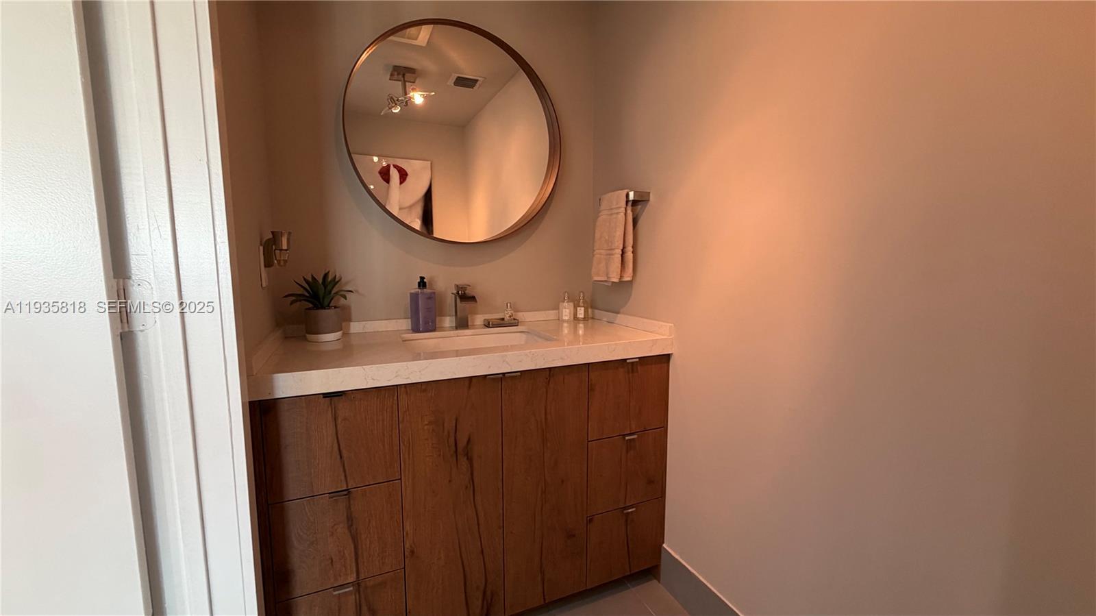 92 Southwest 3rd Street, Unit 3607 Miami, FL 33130 - Photo 31 of 33 a bathroom with a sink vanity and a mirror