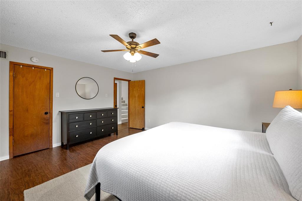 3000 North 15th A Street Waco, TX 76708 - Photo 14 of 24 a bedroom with a bed and a chandelier