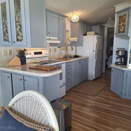 a kitchen with a cabinets a sink and a stove