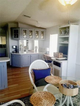 a living room with furniture and kitchen view