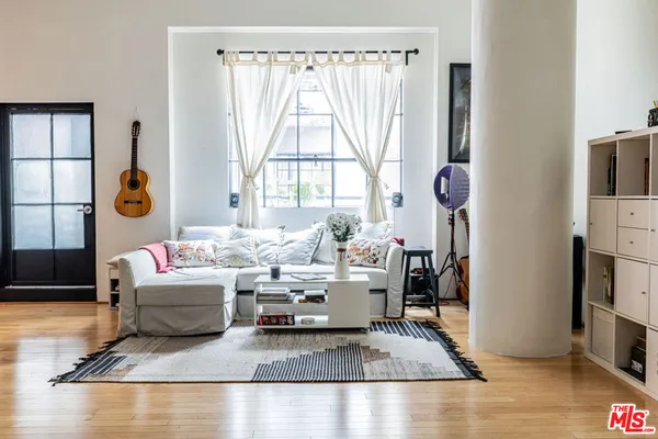 a living room with furniture and a large window