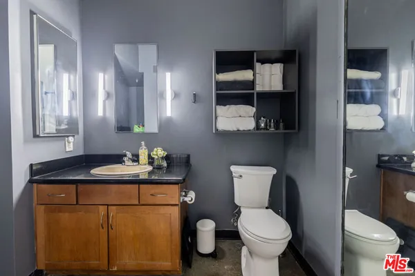 a bathroom with a toilet sink and mirror