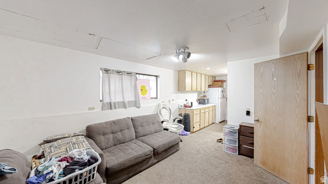 630 1100 West Provo, UT 84601 - Photo 32 of 64 Open-concept living space featuring carpet flooring, white walls, and a multi-light flush mount ceiling fixture
