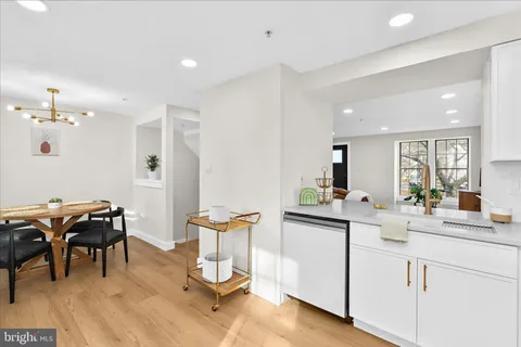 a kitchen with a sink and chairs