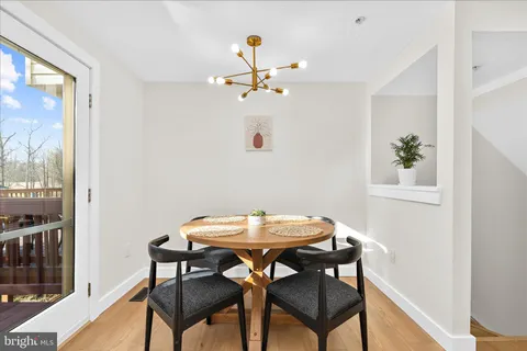 a view of a dining room with furniture and a window