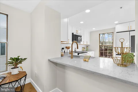 a kitchen with a sink appliances and a counter top space